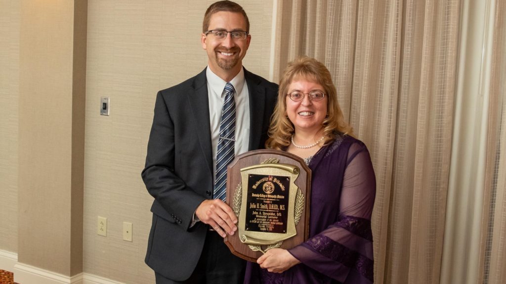 KYCOM Dean Dr. Joe Kingery presents Dr. Julia H. Smith with the John A. Strosnider Memorial Lecturer award.