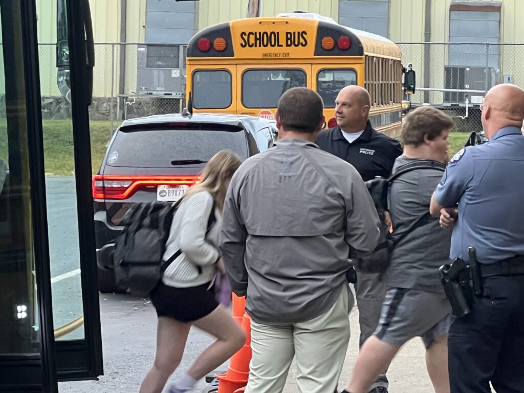Prestonsburg Police officers and detectives greet students as they exit their bus at Adams Middle School Friday morning.