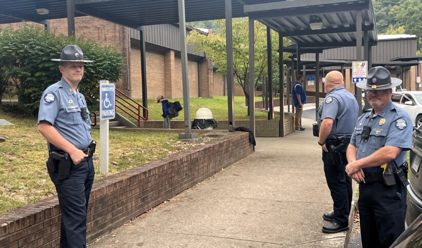 Prestonsburg Police Chief Ros Shurtleff, left, maintains a position outside the entrace to Adams Middle School. "We will find out who did this and someone is going to jail," Shurtleff said.