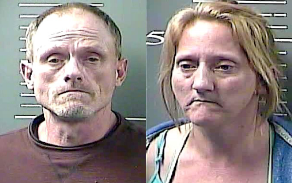 Couple charged with breaking into home