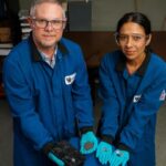Matt Weisenberger and Aman Preet Kaur hold the progression of coal, from raw resource to finished battery. (Photo by Jeremy Blackburn, UK Research Communications.)
