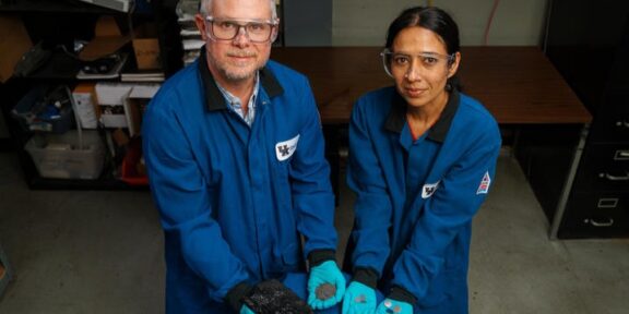 Matt Weisenberger and Aman Preet Kaur hold the progression of coal, from raw resource to finished battery. (Photo by Jeremy Blackburn, UK Research Communications.)