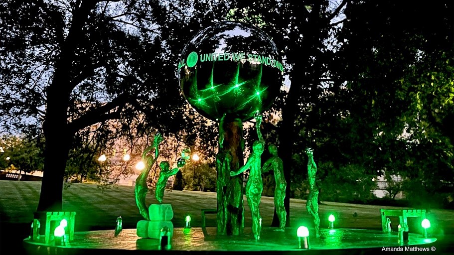The COVID memorial will be lit green at sunset, in honor of those killed by the virus.