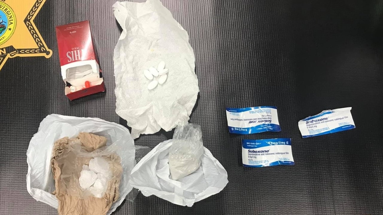 Police: Woman tried to hand purse full of drugs to 8-year-old