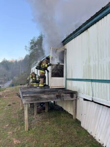 A W.R. Castle firefighter makes entry into the home.