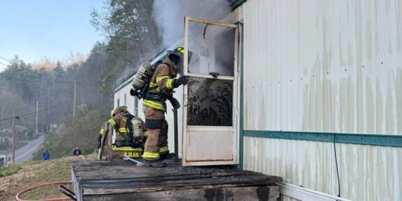 A W.R. Castle firefighter makes entry into the home.