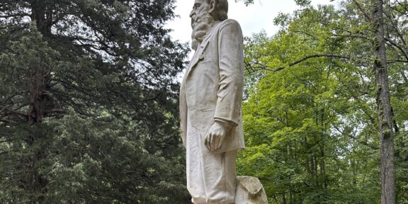 The statue of Hatfield patroarch Devil Anse Hatfield stands guard at the mountainside cemetery at Sarah Ann, West Virginia. It is on the National Register of Historic Places. (Photo by Emery Jeffreys)