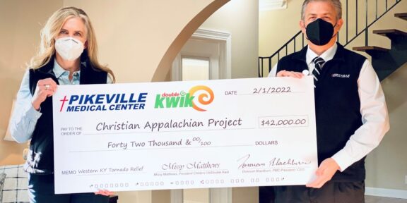 Childers Oil and Double Kwik President Missy Matthews and Pikeville Medical Center President and CEO Donovan Blackburn present a check for $42,000 to Christian Appalachian Project for tornado relief.