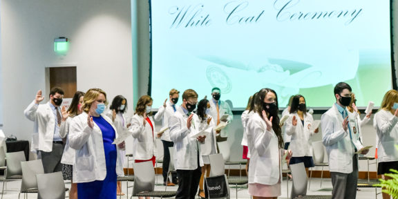Second-year students at the Kentucky College of Optometry take part in a white-coat ceremony.