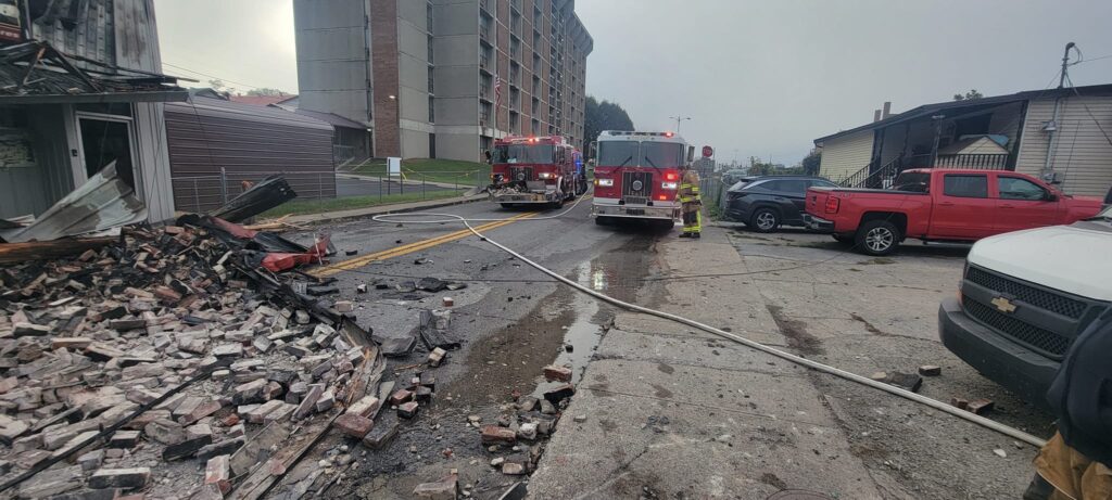 Two Williamson firefighters were injured when a previously-burned building collapsed while they were responding to a re-ignition Sunday morning.